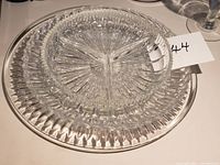 Stacked view of divided dish atop smaller platter on larger platter