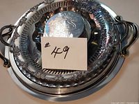 Stack of five trays with handles visible and coaster set on top