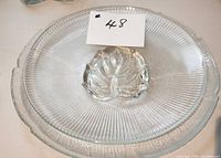 Ribbed glass platter with central leaf design