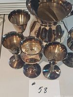 Water pitcher and four goblets grouped together