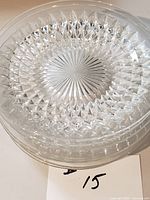 Stack of clear diamond cut glass plates