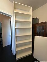 Full view of tall white Billy bookcase with extension unit and shelves