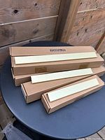 Boxed brushed gold drawer pulls on table