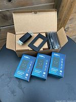 Group shot of boxed rocker switches with plates and three boxed USB receptacles