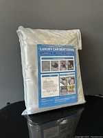 Front of sealed package showing product label Luxury Car Seat Cover