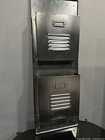 Full view of black metal two-pocket wall organizer front