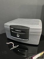 Closed SentrySafe H2100 fire safe with keys shown