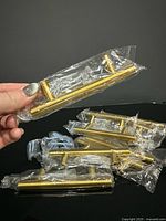 Individually wrapped brass handles showing T-bar form