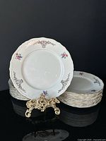 Front view of stacked plates with one displayed on stand