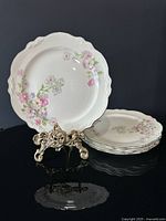 Front view showing floral pattern and stacked plates