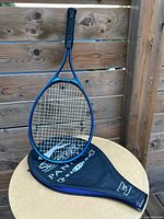 Full view of racket resting on cover showing overall design and colors