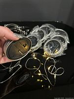 Group of lid lights showing underside battery compartment and lit LED string