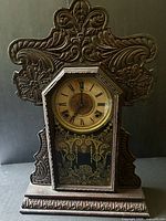 Full view of pressed wood gingerbread mantel clock
