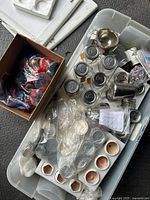 Overview of tote with jars, tins, molds, wax chunks, pouring pitcher