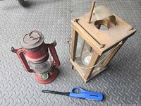 Group view of kerosene lantern, candle lantern and lighter