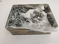 Overview of tin containing loose unpainted lead soldier figures and parts