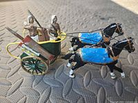 Full view of painted lead Roman chariot set showing horses, wheels, riders