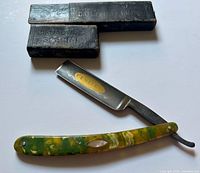 Razor open with handle and box visible