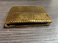 Closed gold mesh wallet side profile