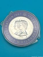 Front of medallion showing Queen Victoria and Queen Elizabeth II portraits and surrounding legend