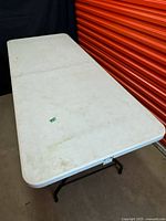 Full view of unfolded table showing surface and legs