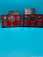 Both proof sets in display cases