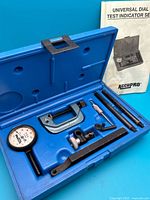 Open blue Accupro case showing dial indicator, clamps, rods and accessories