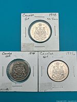 Front view of all three coin holders showing 1978, 1974, 1976 Canada 50-cent coins