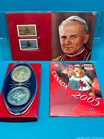 All three items: coin capsule in red sleeve, Pope John Paul II stamp pack, Canada 2005 coin folder