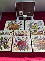 All eight floral mats laid out with box