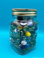 Glass marbles inside embossed Canadian Mason jar with lid