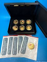 Full set showing six coins in box with certificates