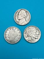 Obverse faces of three nickel coins dated 1906, 1936, 1948