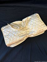 Rolled-up quilted vinyl jewelry organizer