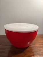 Red bowl with white lid profile view