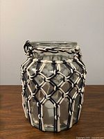 Front view of clear glass jar with macrame
