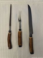 Full view of three utensils on cloth