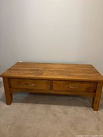 Full view of coffee table with drawers and legs