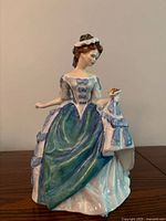 Front view of Royal Doulton Linda figurine showing dress colors and pose