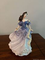 Front view of figurine showing full gown and pose