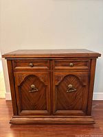 Front view showing drawers, doors, handles and overall design