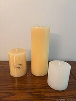 Group shot of three pillar candles showing sizes and colours