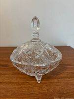 Full view of crystal candy dish with lid on wooden surface