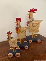 All three wooden chickens shown together on table