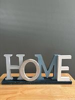 Front view of complete wooden HOME letter block decor on base