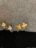 Front view showing both pairs of Mickey Mouse clip-on earrings