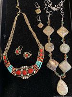Both necklace and earring sets displayed