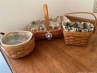 Group shot of three Longaberger baskets showing sizes, liners, protectors and handles