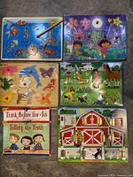 All five wooden puzzles laid out together