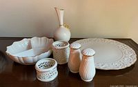 Group shot showing all eight Lenox ivory porcelain pieces